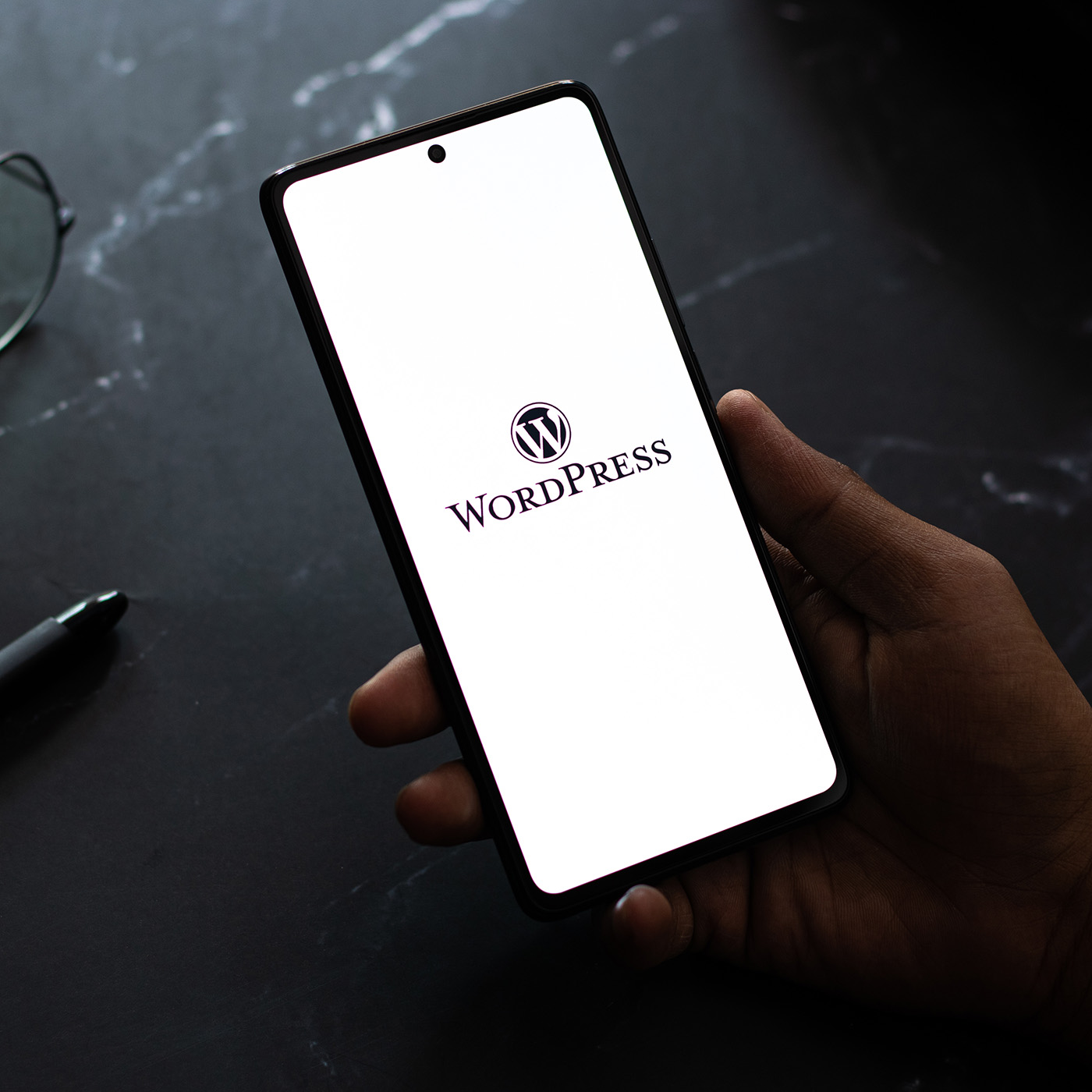 WordPress web hosting - WP logo shown on mobile phone